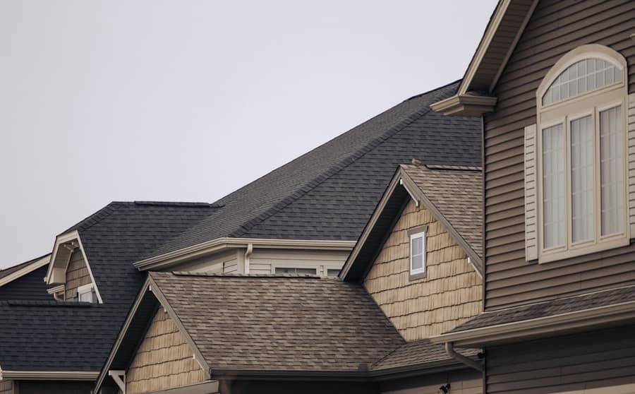 Roof detail where a chimney meets the shingles
