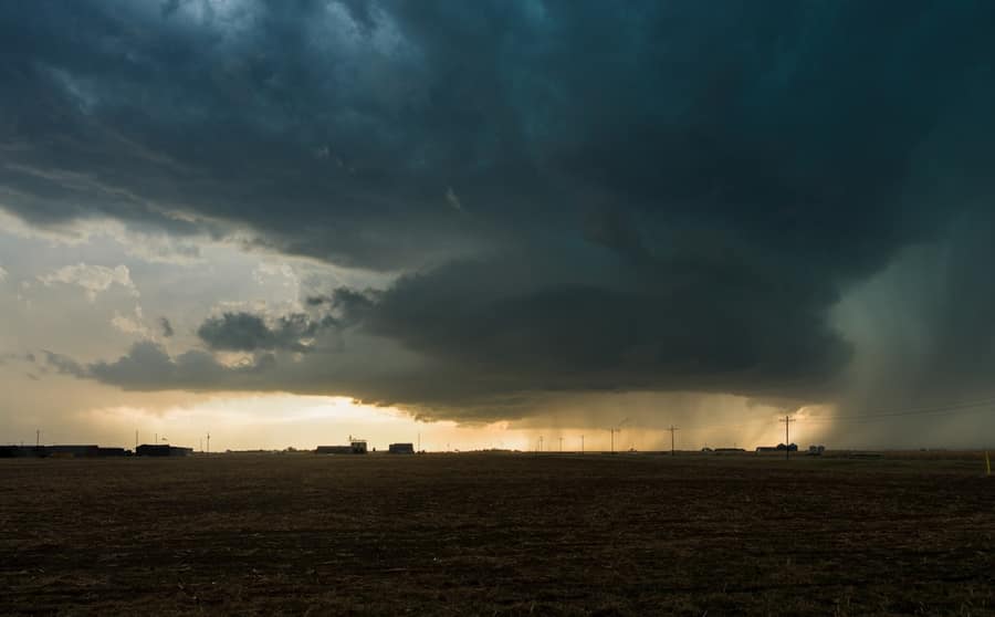 Storm cloud over flat farmland